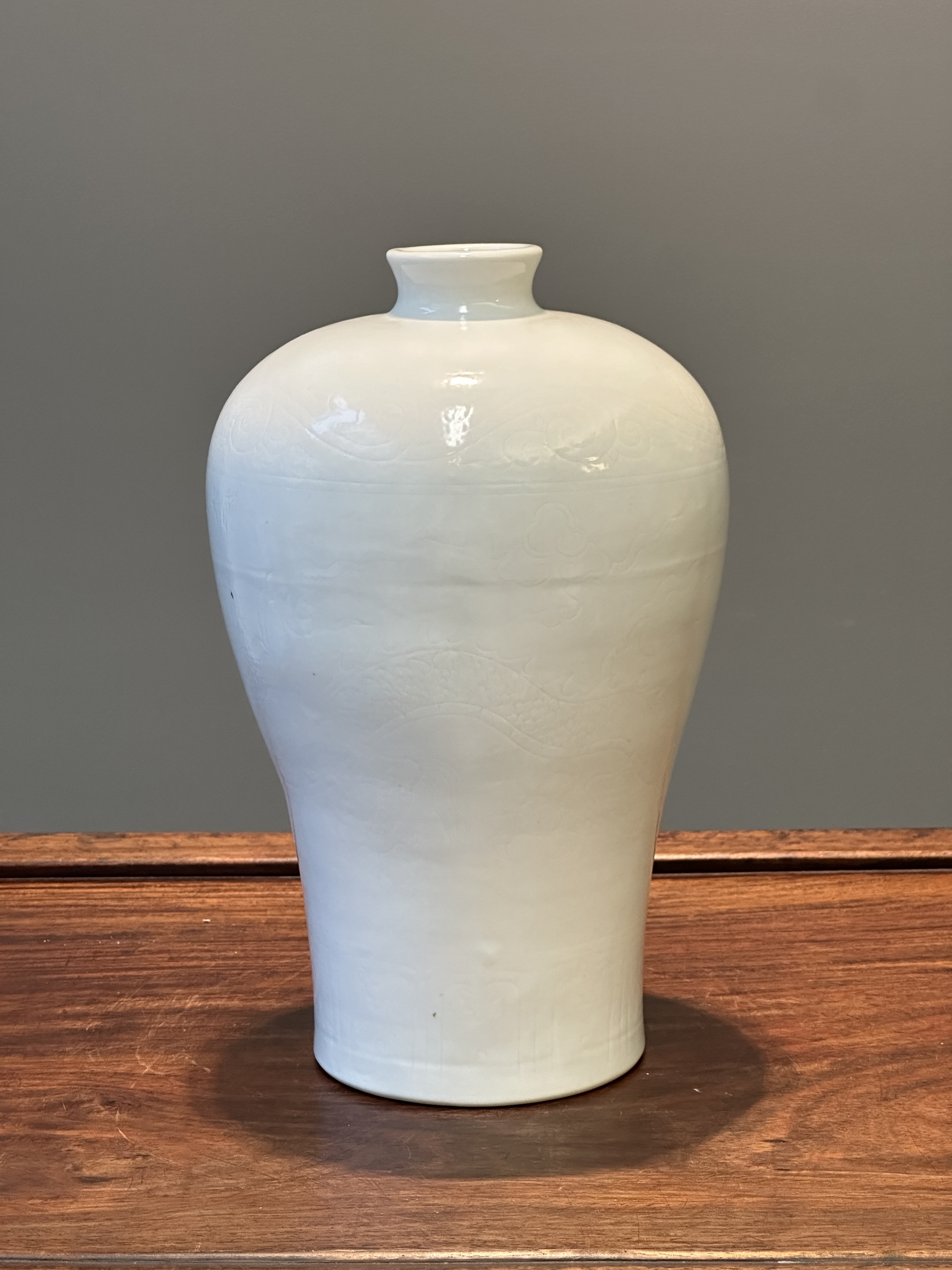 A Chinese monochrome white-glazed 'meiping' vase with anhua dragon ...