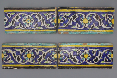 A set of 4 Isfahan cuerda seca border tiles, 18/19th C.