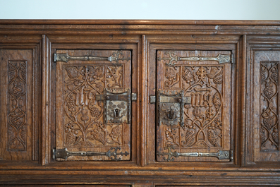 A Flemish oak credence with IHS panels, 16th C. with later adaptations