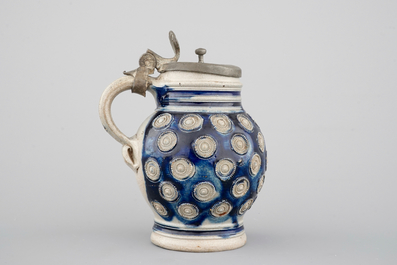 A globular Westerwald stoneware jug with appliques and pewter lid, dated 1689