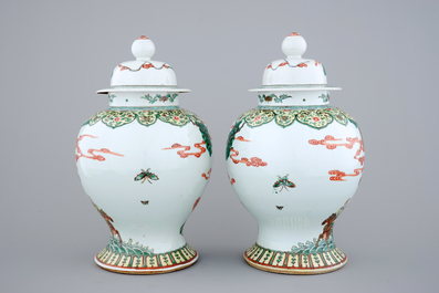 A pair of Chinese wucai porcelain warrior vases with covers, 19/20th C.