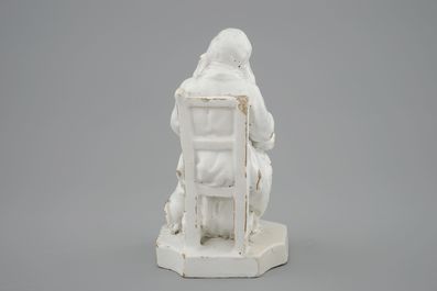 A monochrome white faience group of a seated lady, 18th C., poss. Brussels