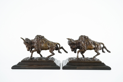 A pair of bronze buffalos on wood stand, 20th C.