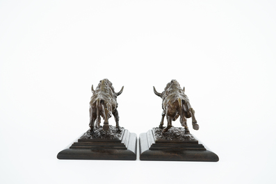 A pair of bronze buffalos on wood stand, 20th C.