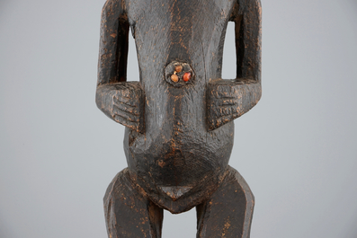 An African carved wood fetish figure on stand, Songye, Congo, mid 20th C.