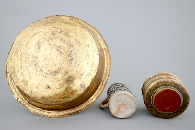 A Malines brass alms dish, a Nuremberg brass alms bowl, an Italian bronze holy water bucket and a Westerwald stoneware beer stein, 16/18th C.