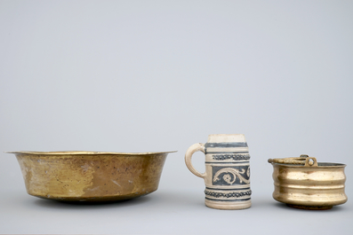 A Malines brass alms dish, a Nuremberg brass alms bowl, an Italian bronze holy water bucket and a Westerwald stoneware beer stein, 16/18th C.