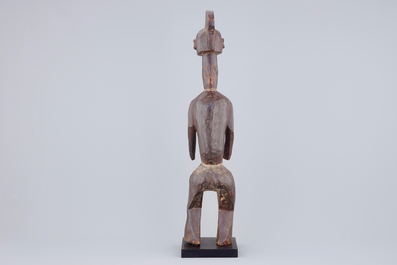 An African carved wood figure, 3rd quarter 20th C.