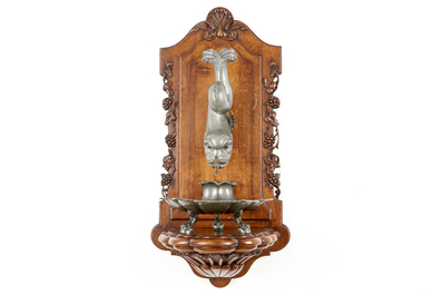 A pewter wall fountain and basin on a carved wood stand, 18/19th C.