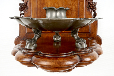 A pewter wall fountain and basin on a carved wood stand, 18/19th C.