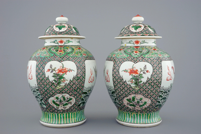 A pair of Chinese famille verte vases and covers with mythical beasts, 19/20th C.