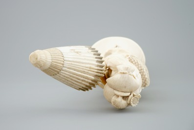 A Japanese carved ivory okimono of a lady holding a parasol, 19th C.