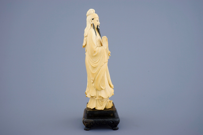 A Chinese ivory figure of a sage with a parchment roll on stand, late 19th C.