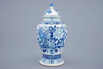 A Chinese blue and white vase and cover with dragons and peonies, 19th C.