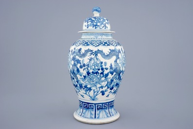 A Chinese blue and white vase and cover with dragons and peonies, 19th C.