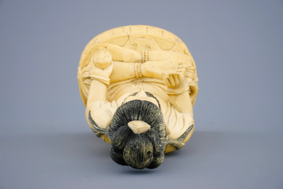 A Chinese carved ivory figure of a seated Buddha, 19th C.