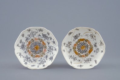 A pair of Chinese grisaille and gilt cups and saucers with insects among fruits and flowers, Yongzheng, 1723-1735