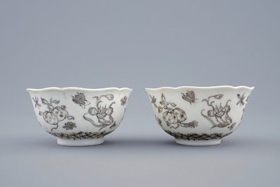 A pair of Chinese grisaille and gilt cups and saucers with insects among fruits and flowers, Yongzheng, 1723-1735