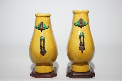 A pair of Chinese yellow glazed hu-shaped vases on stand, 19/20th C.