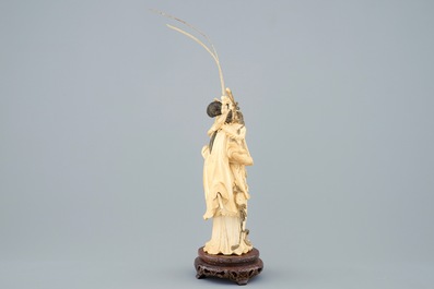 A Chinese carved ivory figure of Hua Mulan on a wooden base, late 19th C.