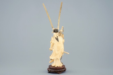 A Chinese carved ivory figure of Hua Mulan on a wooden base, late 19th C.