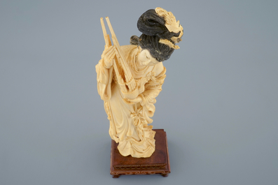 A Chinese carved ivory figure of a lady on wooden base, ca. 1900