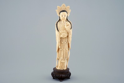 A Chinese carved ivory figure of Guanyin on wooden base, early 20th C.