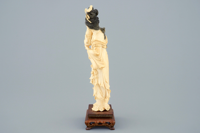 A Chinese carved ivory figure of a lady on wooden base, ca. 1900