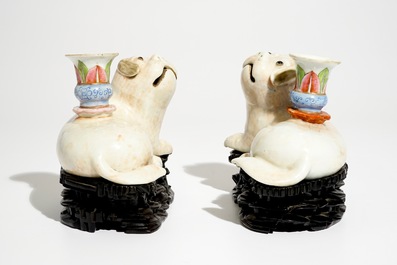 A pair of Chinese famille rose dog-shaped candle holders, 18/19th C.