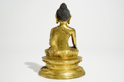 A Chinese gilt bronze figure of Buddha, 18/19th C.