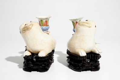 A pair of Chinese famille rose dog-shaped candle holders, 18/19th C.
