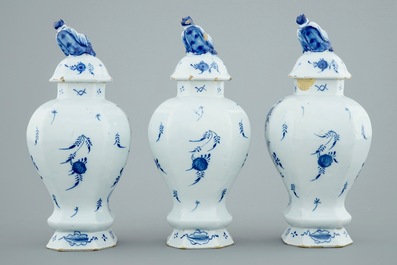 A Dutch Delft blue and white three-piece garniture with chinoiserie landscapes, 18th C.