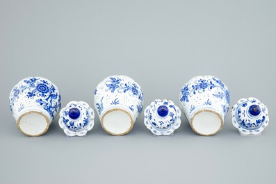 A tall blue and white Dutch Delft five-piece garniture with parrots among foliage, 18th C.