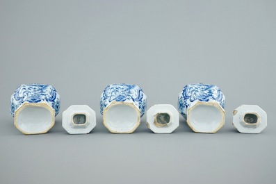 A Dutch Delft blue and white three-piece garniture with chinoiserie landscapes, 18th C.