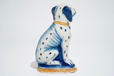 A polychrome Dutch Delft model of a seated dog, 18th C.