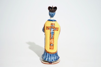 A large Dutch Delft polychrome figure of a standing priest, 18th C.