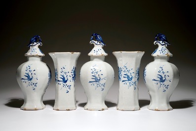 A Dutch Delft blue and white five-piece garniture with a hunter, 19th C.