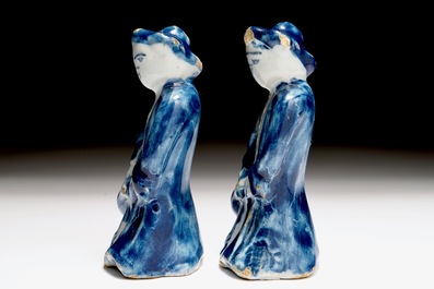 A pair of Dutch Delft blue and white miniatures of men with a jug, 18th C.