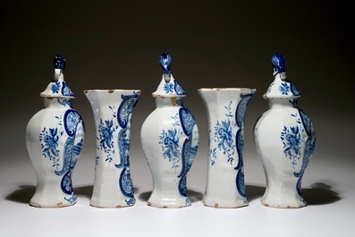 A Dutch Delft blue and white five-piece garniture with a hunter, 19th C.