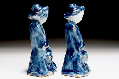 A pair of Dutch Delft blue and white miniatures of men with a jug, 18th C.