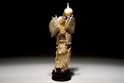 A Chinese carved ivory figure of a warrior on a wooden base, late 19th C.