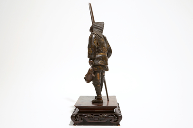 A Japanese bronze figure of a fisherman, signed Miyao, on a wooden stand