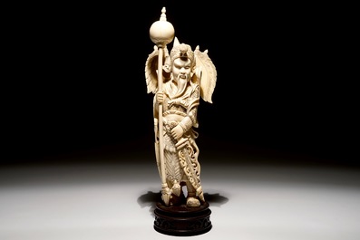 A Chinese carved ivory figure of a warrior on a wooden base, late 19th C.