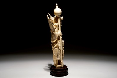 A Chinese carved ivory figure of a warrior on a wooden base, late 19th C.