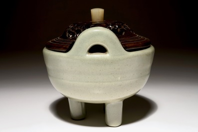 A Chinese tripod celadon censer with jade-inset wooden cover, 19th C.