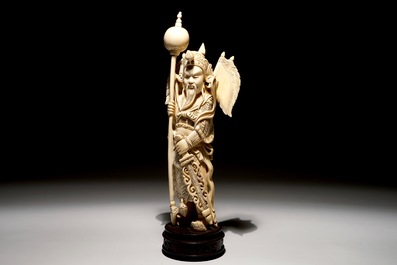 A Chinese carved ivory figure of a warrior on a wooden base, late 19th C.