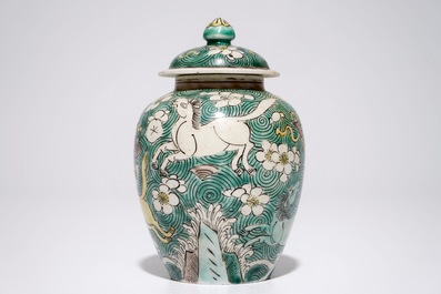 A Chinese verte biscuit covered jar with horses, Kangxi