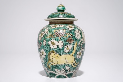 A Chinese verte biscuit covered jar with horses, Kangxi