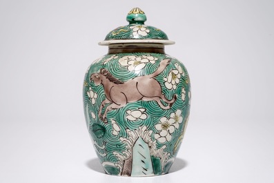 A Chinese verte biscuit covered jar with horses, Kangxi