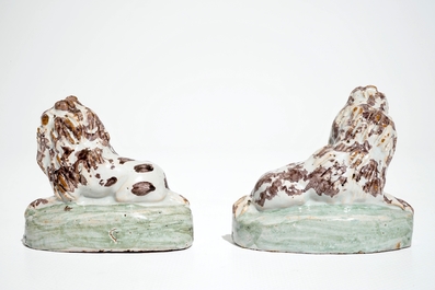 A pair of polychrome Brussels faience models of dogs, 18th C.